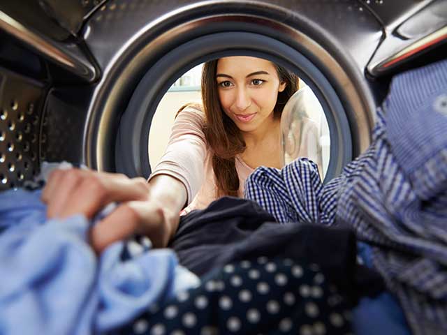 Resident doing laundry at on-site Clothes Care Center