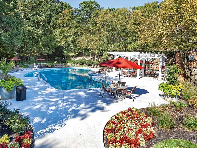 Beautifully landscaped community pool area at Overlook At Flanders Apartments